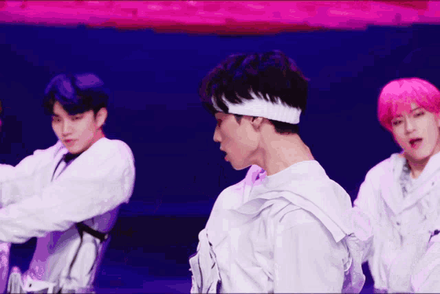 a man with a white headband on his head is dancing