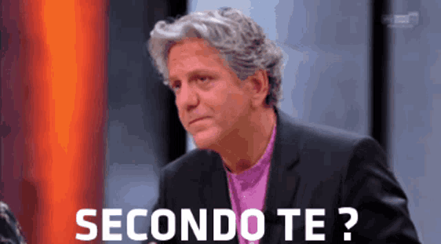 a man in a suit and purple shirt says secondo te ?