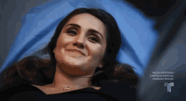 a woman is laying in a hospital bed with a t on the bottom right
