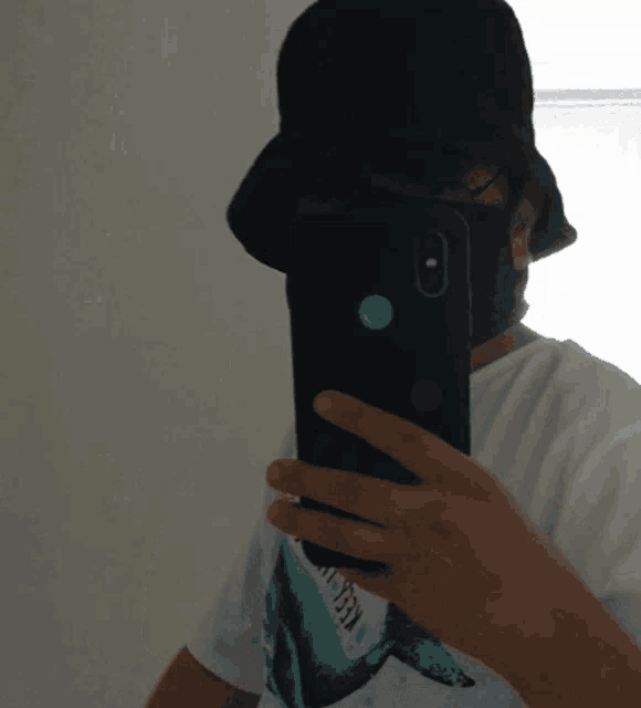 a person taking a picture of themselves with a phone