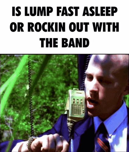 a man in a suit and tie is talking into a walkie talkie with the words is lump fast asleep