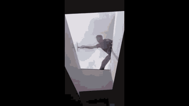 a man in a red shirt is standing in a skylight .