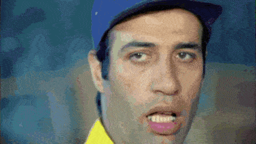 a man wearing a blue hat and a yellow shirt