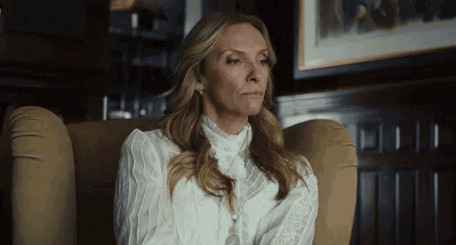 a woman is sitting in a chair with her eyes closed