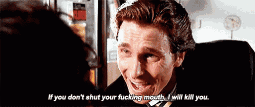 a man in a suit and tie is smiling while talking to another man .