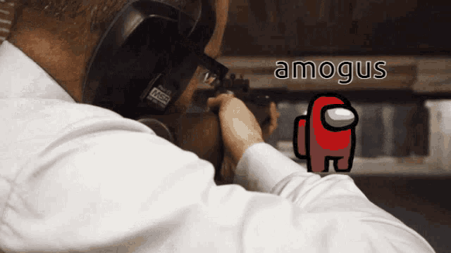 a man is aiming a gun at a red among us icon