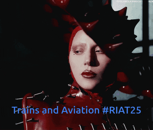 lady gaga is wearing a red outfit with spikes and the words trains and aviation