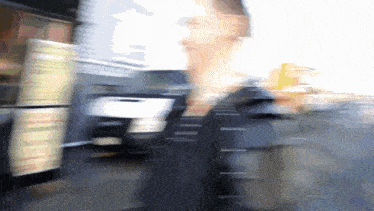a blurry picture of a person walking in front of a building