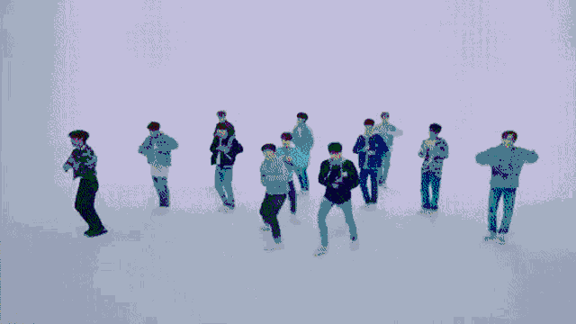 a group of young men are dancing in front of a purple light .