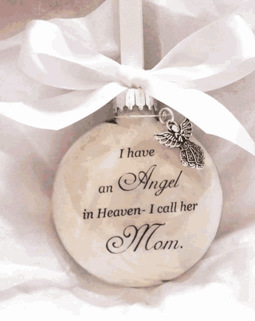 a white ornament that says " i have an angel in heaven - i call her mom "
