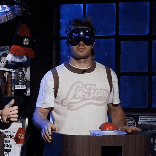 a man wearing a shirt that says l * jam stands in front of a podium