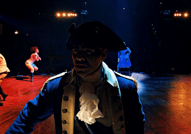 a blurry picture of a man in a pirate costume on a stage