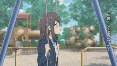 a girl sitting on a swing in a park with chinese writing on the fence