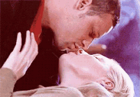 a man and a woman are kissing each other on the lips