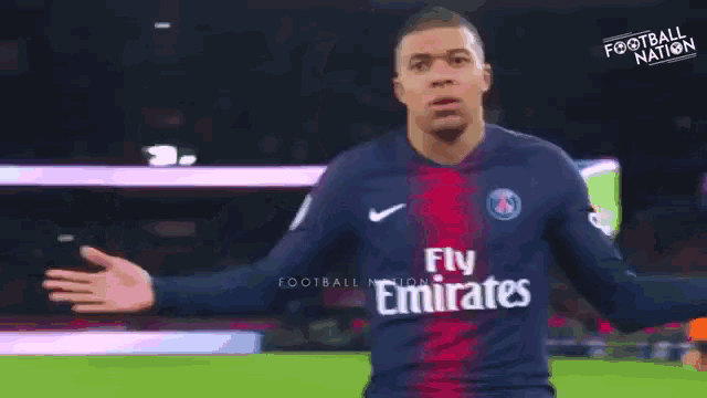 a soccer player in a fly emirates jersey