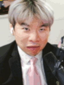a man in a suit and tie is making a face .