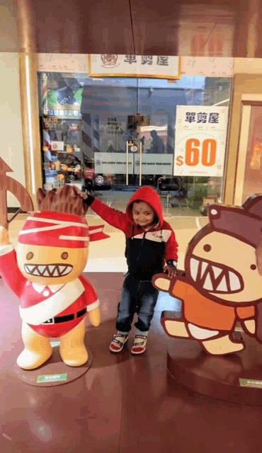 a little boy stands in front of a sign that says 60 dollars
