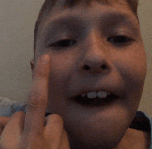 a close up of a person 's face with their middle finger up