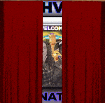 two men are standing in front of a welcome sign