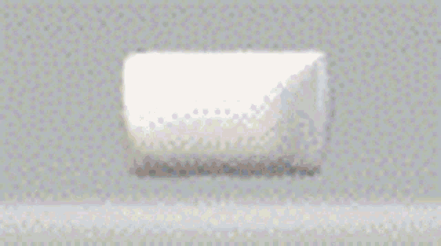 a white marshmallow is sitting on a table .