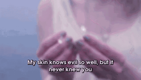a woman holding a piece of paper with the words " my skin knows evil so well but it never knew you " written on it