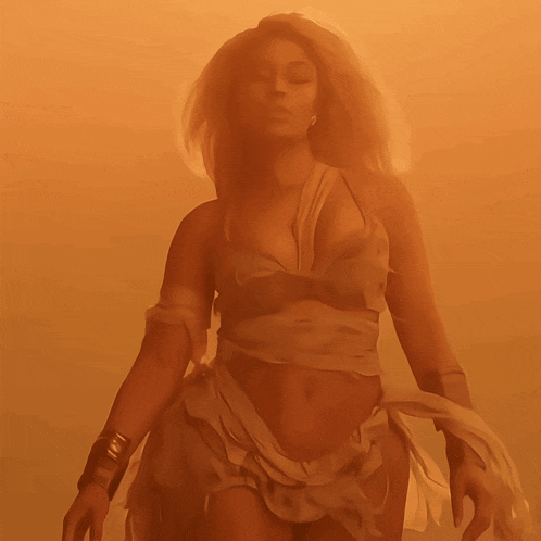 a woman in a very revealing outfit is standing in a foggy room