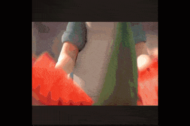 a close up of a person holding a red object in their hands