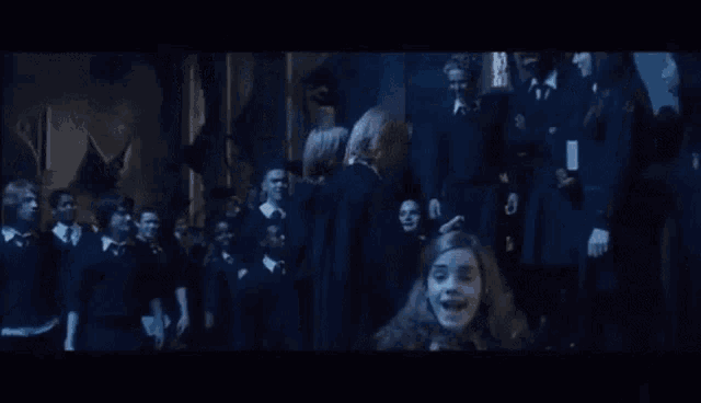 a group of people are standing in a dark room in a dark room .
