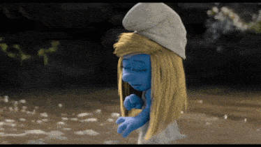a smurf with blonde hair and a white hat stands in the water