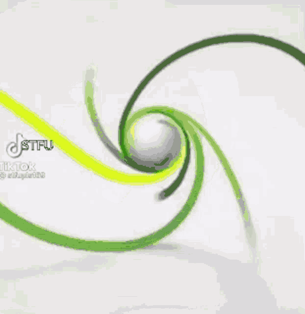 a white ball is spinning on a green and white circle .