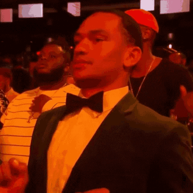a man in a green suit and bow tie