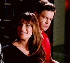 a man and a woman are standing next to each other in a room .