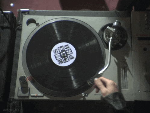 a person is playing a record on a turntable that has a label that says ' aespagifs '
