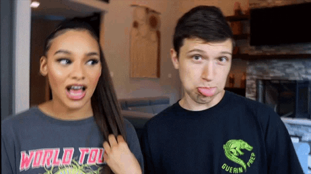 a man and a woman are making funny faces and the man is wearing a shirt that says world tour