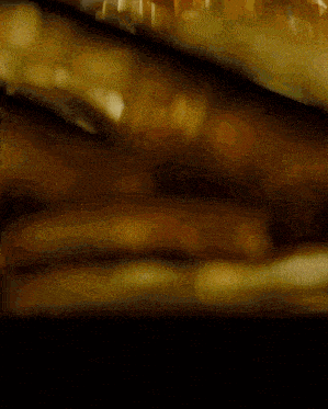 a blurred image of a brown background with a few spots of light