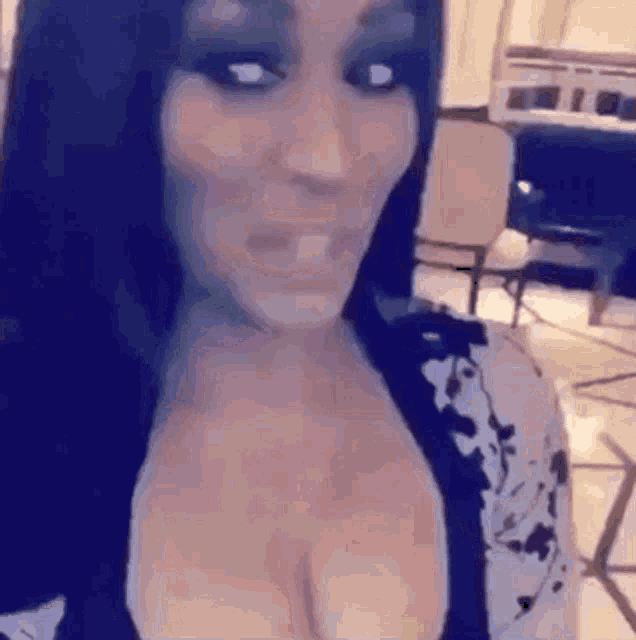 a close up of a woman 's face with her breasts visible .