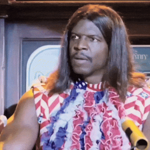 a man with long hair is wearing a red white and blue shirt and a lei .