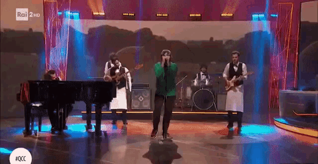 a band performs on a stage with rai 2 hd in the corner