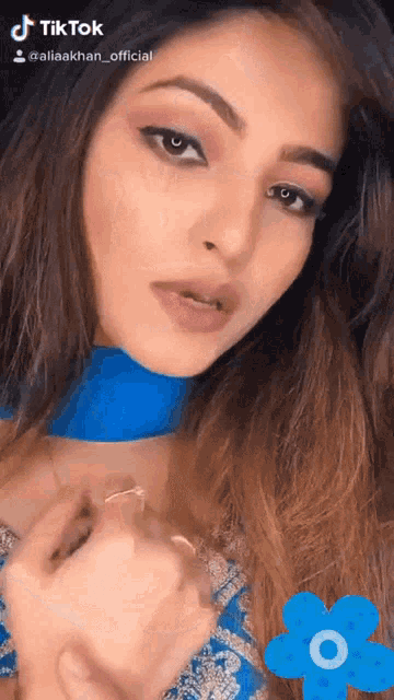 a woman in a blue dress has a tiktok account