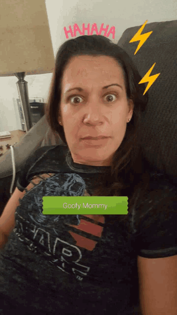 a woman wearing a shirt that says goofy mommy is making a funny face