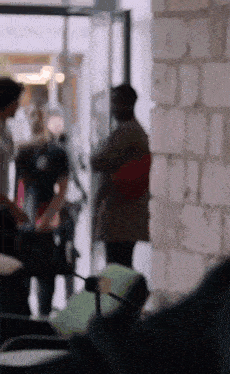 a blurry picture of people standing in front of a building