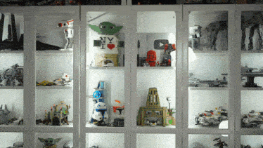 a display case with a yoda wearing a ny i love shirt
