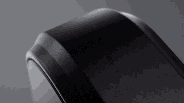 a close up of a black object against a gray background .