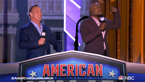 two men stand behind a podium that says american on it