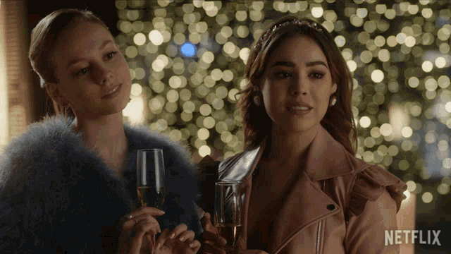two women standing next to each other with a netflix logo on the bottom
