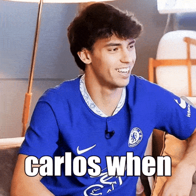 a man wearing a blue shirt that says carlos when on it