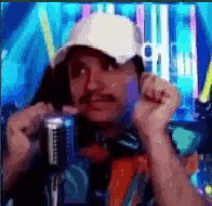 a man with a mustache is wearing a white hat