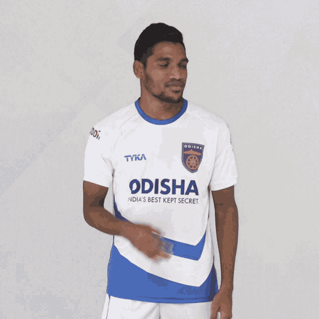 a man wearing a white and blue odis shirt
