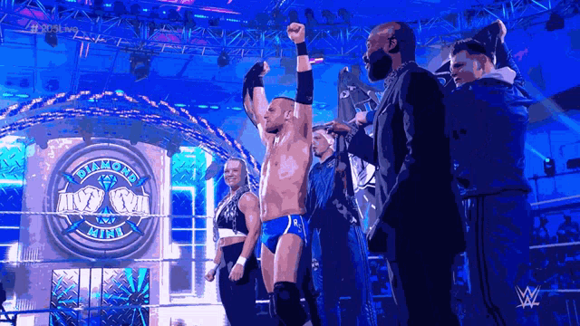 a wrestler stands in front of a sign that says diamond ring