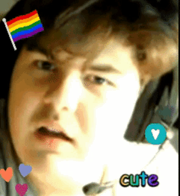 a close up of a person 's face with a rainbow flag and the word cute below it